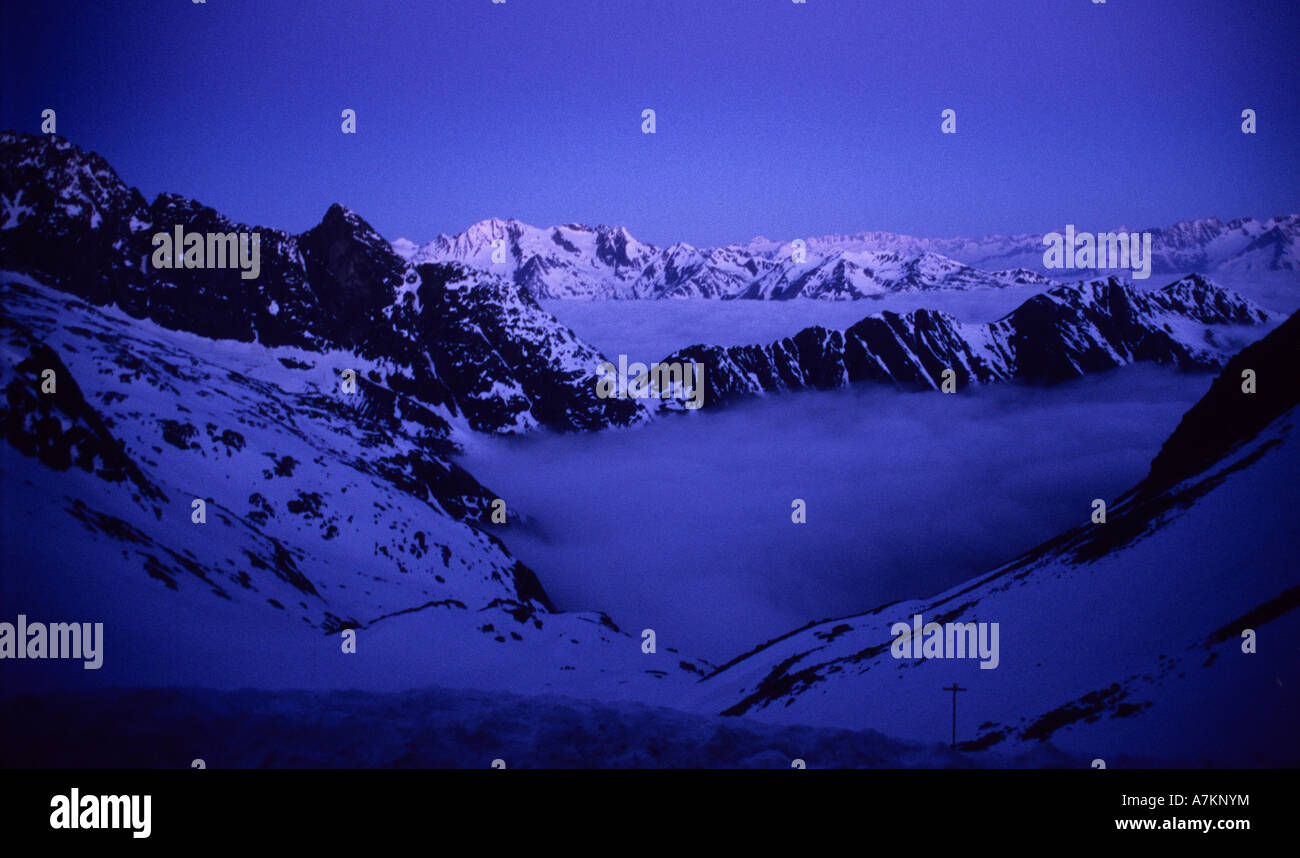 Low hanging clouds in the valley and the first light on the distant ...