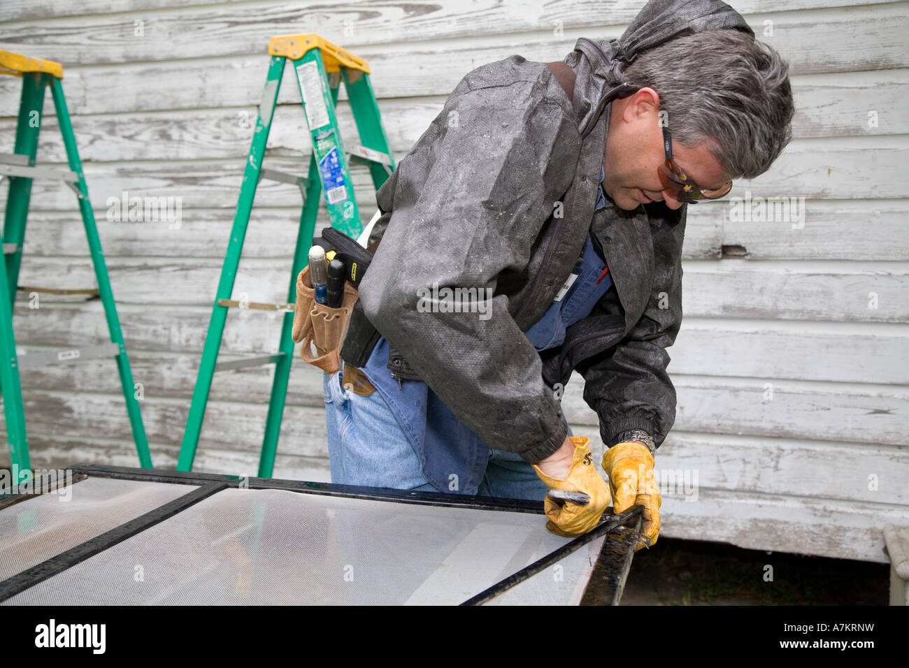 Volunteer Repairs Home for Family Stock Photo Alamy