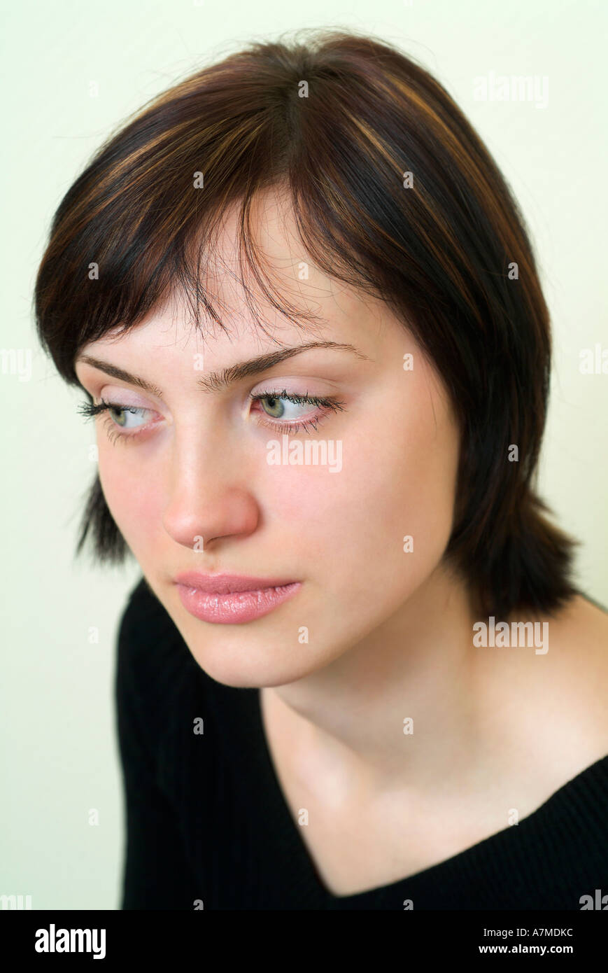 Young woman with short brown hair looking away Stock Photo Alamy