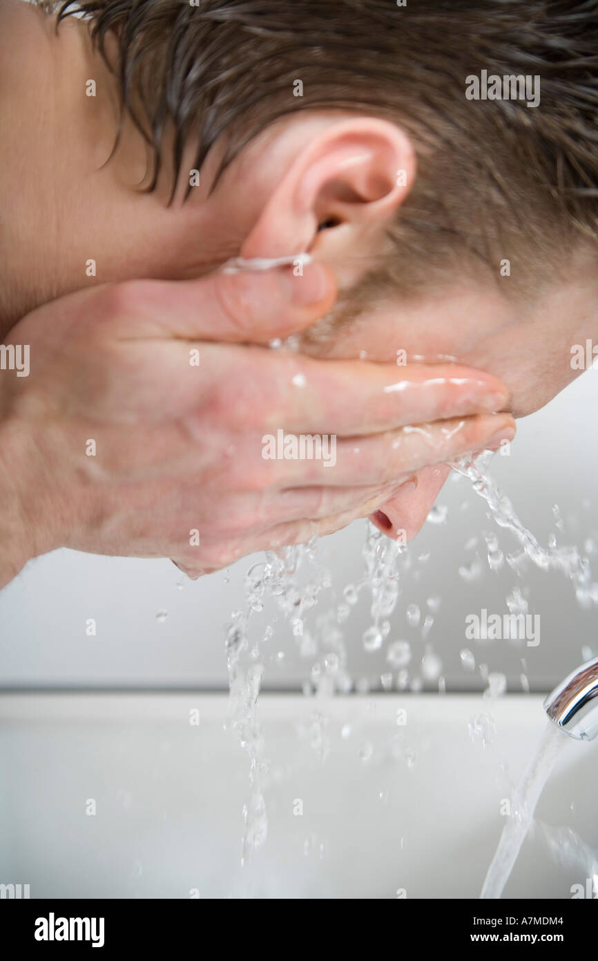 Man splashing water on his face after shaving Stock Photo Alamy