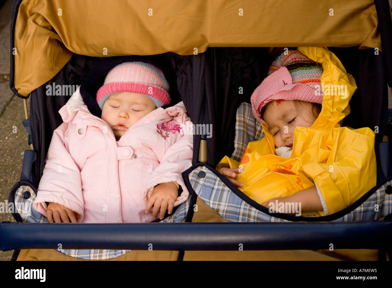 Two girls sleeping in baby stroller Stock Photo Alamy