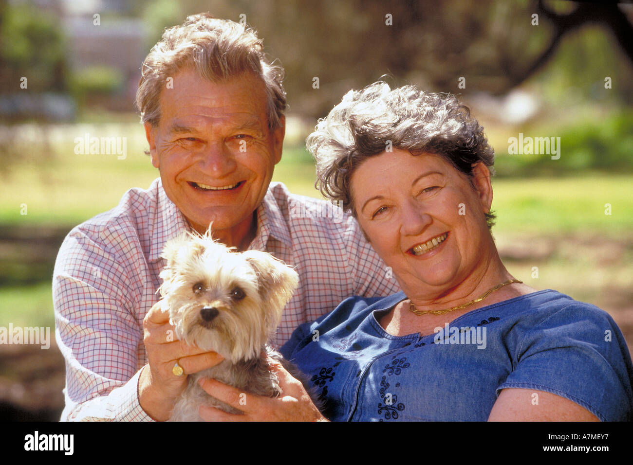portrait of elderly couple sitting outdoor with a dog Stock Photo - Alamy