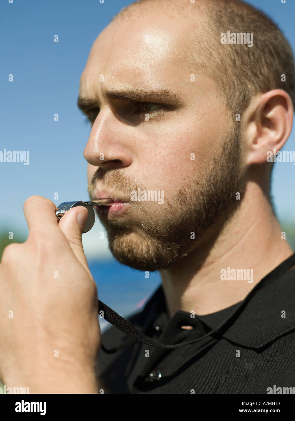 A referee blowing a whistle Stock Photo Alamy