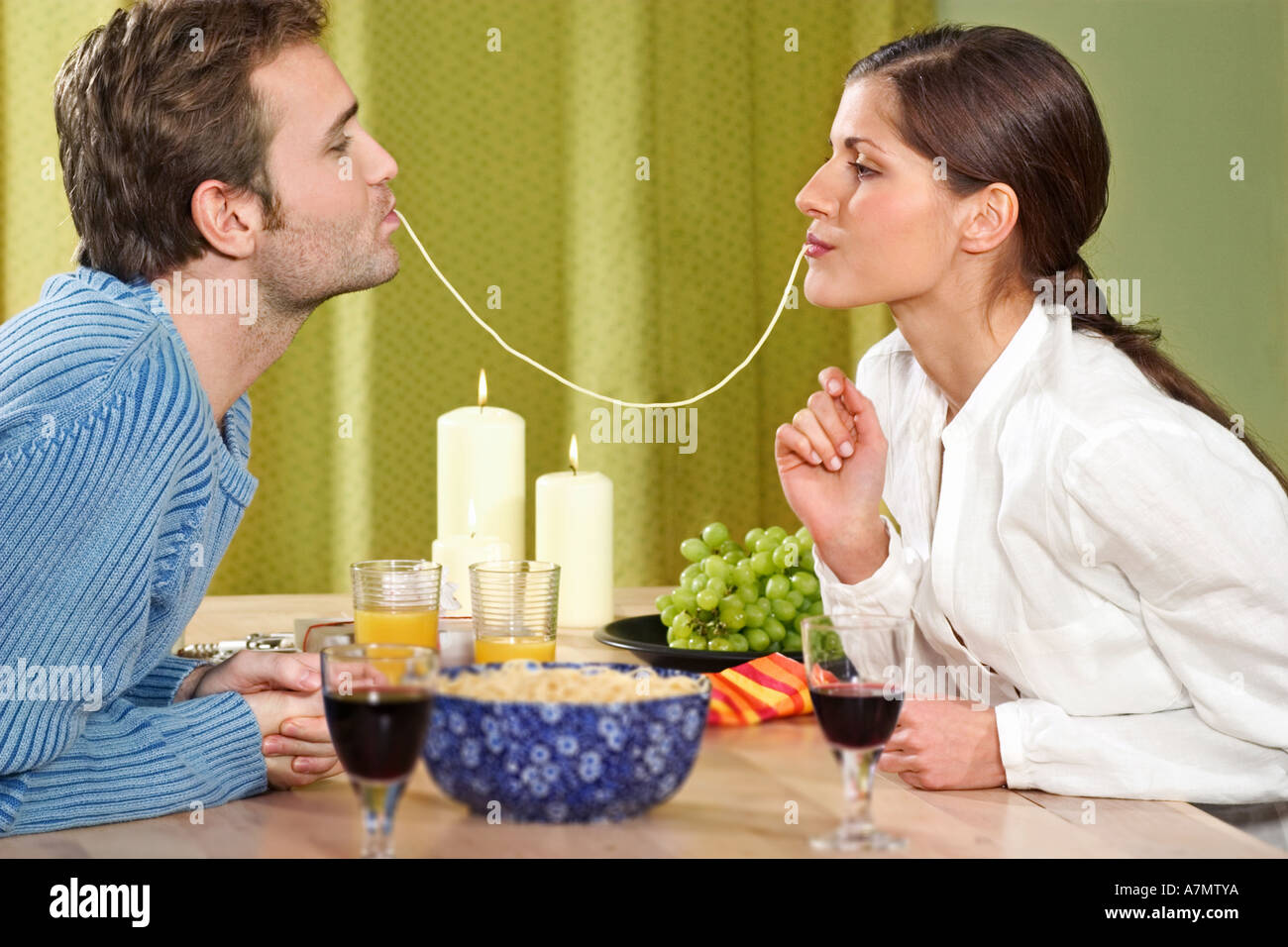 Young couple eating dinner at home Stock Photo - Alamy