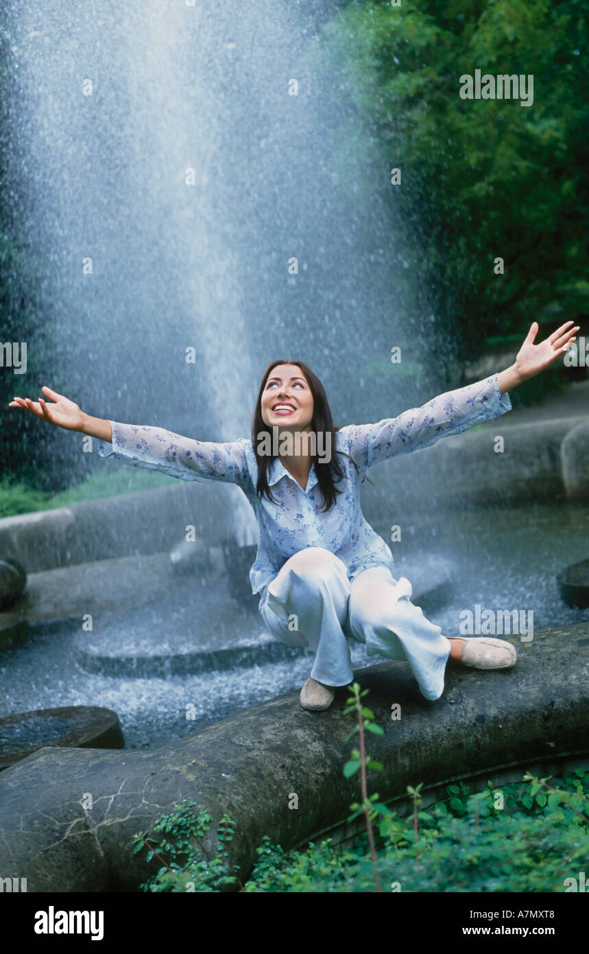 Young woman sitting at fountain hi-res stock photography and images - Alamy
