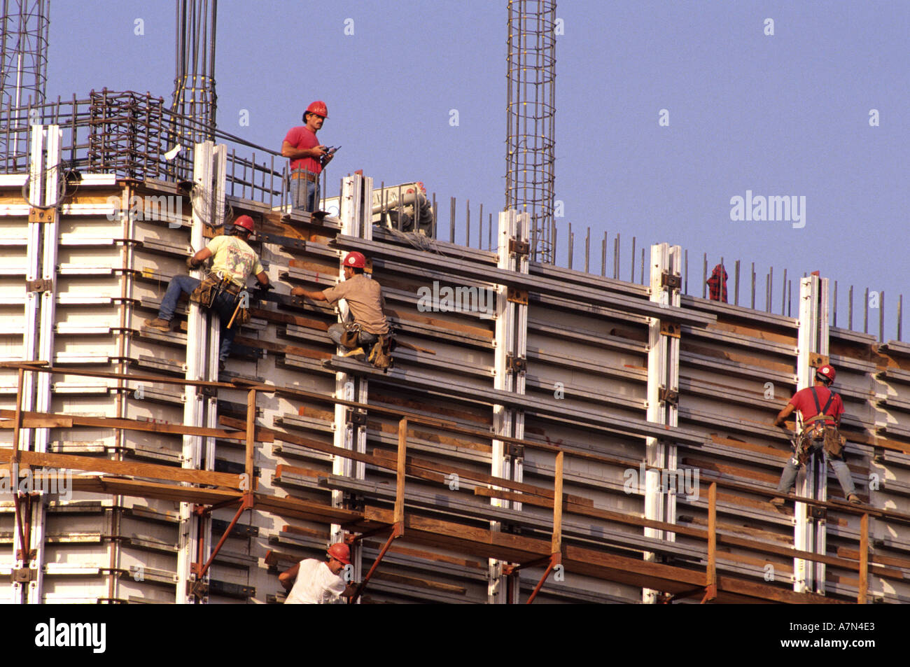Construction workers work with rebar on a new concrete building Stock