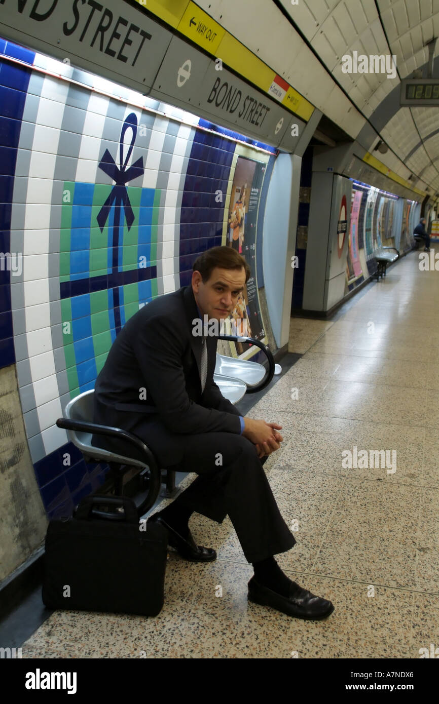 City gent on London Underground station waiting for train England
