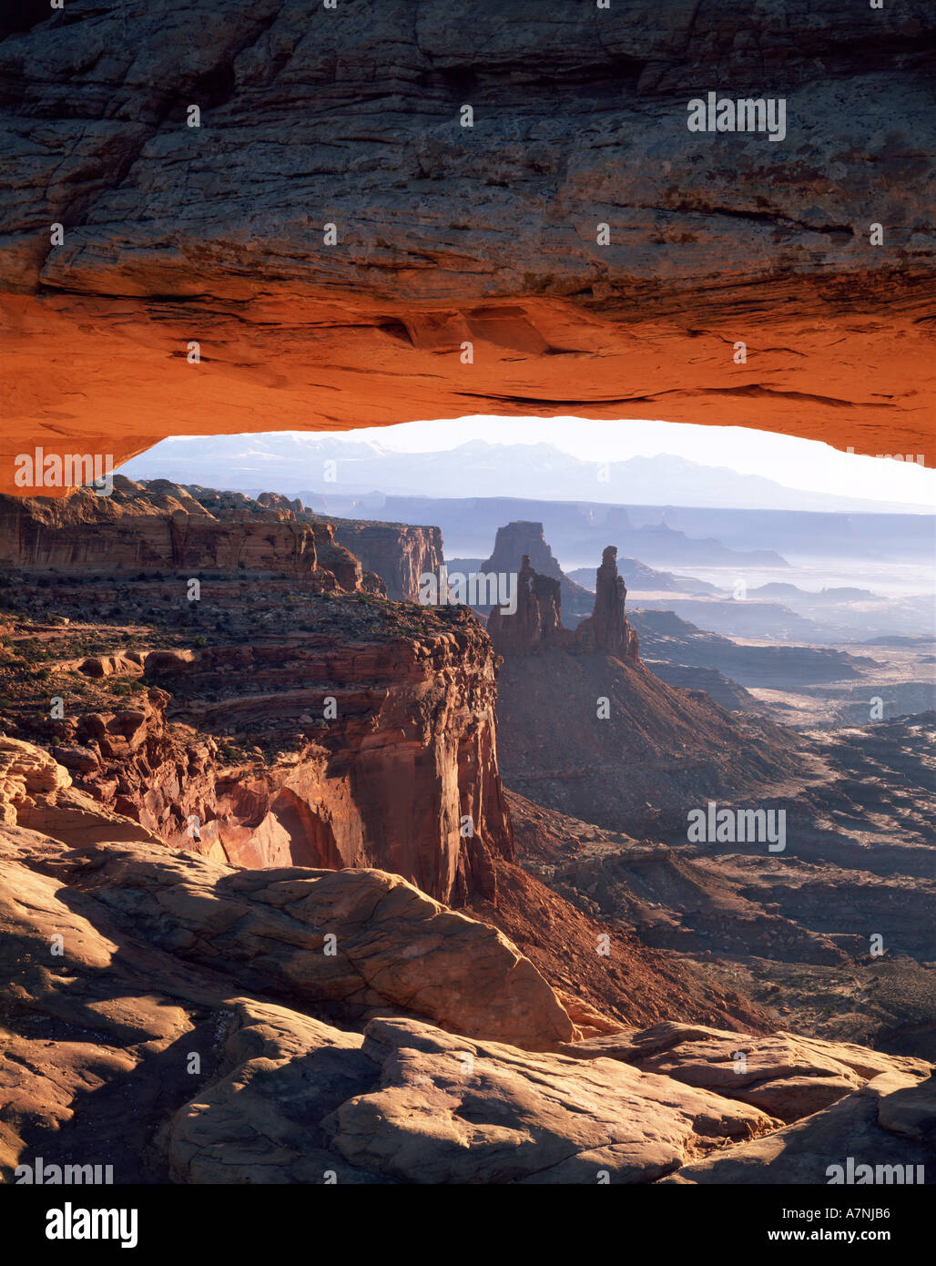 CANYONLANDS NP, Utah, Mesa Arch, sunrise. Washerwoman Arch, Airport Tower, La Sal Mtns distance, Island in the Sky. Stock Photo