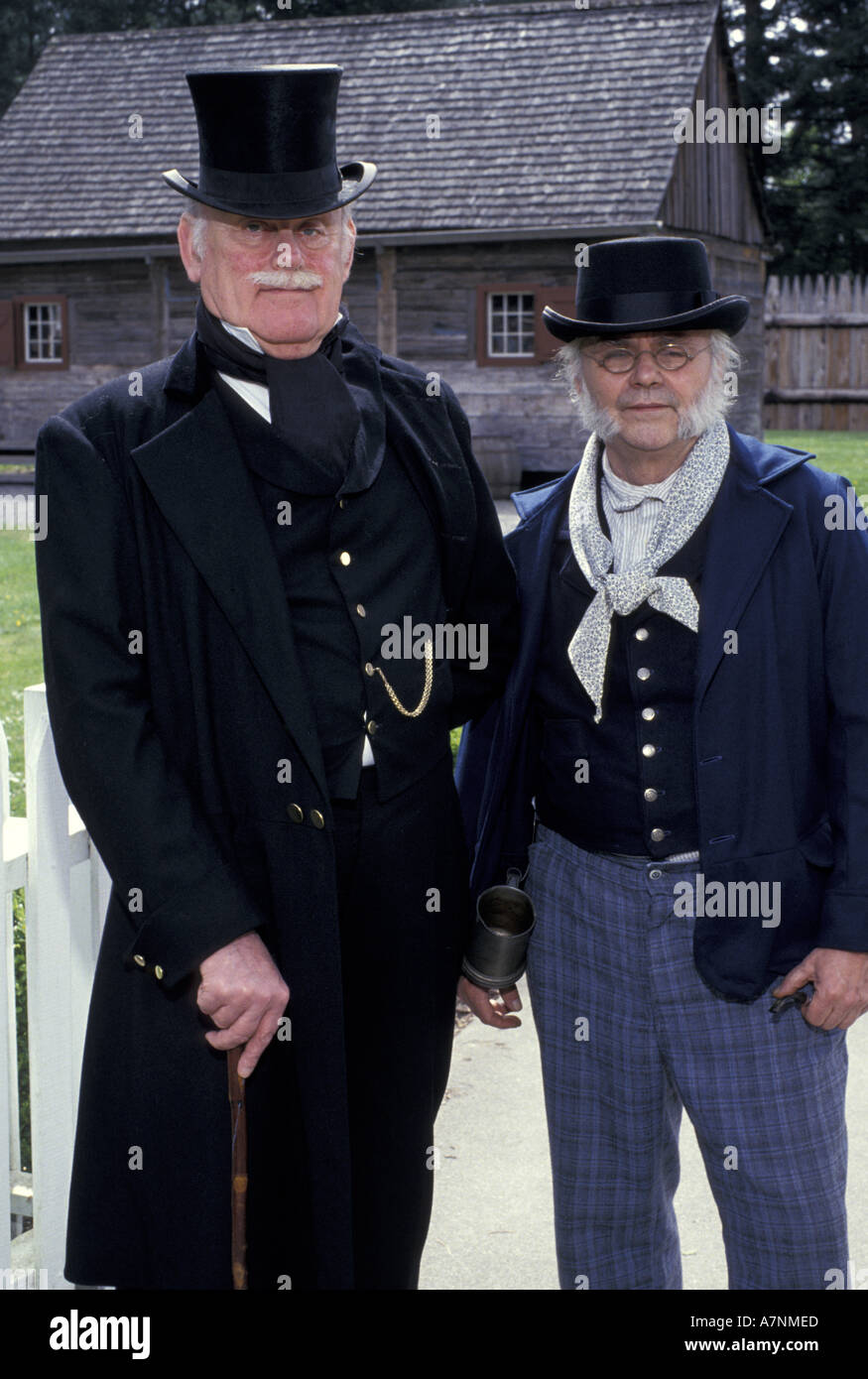 USA, Washington State, Tacoma, Fort Nisqually Historic Site. Men in traditional 1850's laborer and dress costumes (MR) Stock Photo