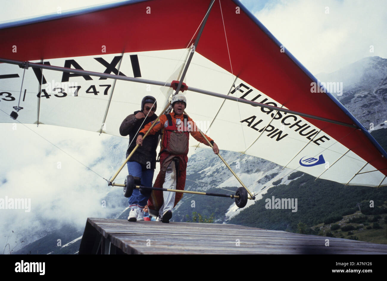 Hang glider taxi - an Austrian hang glider pilot and his passenger run ...