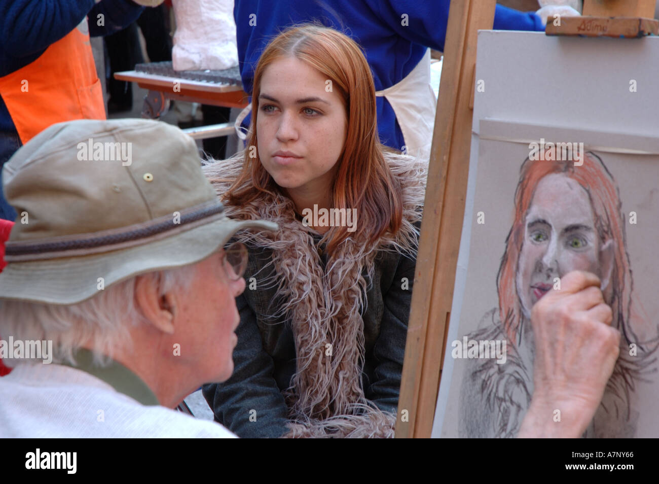 Bad portrait - this young lady in Amsterdam will get a surprise when she sees the finished drawing Stock Photo