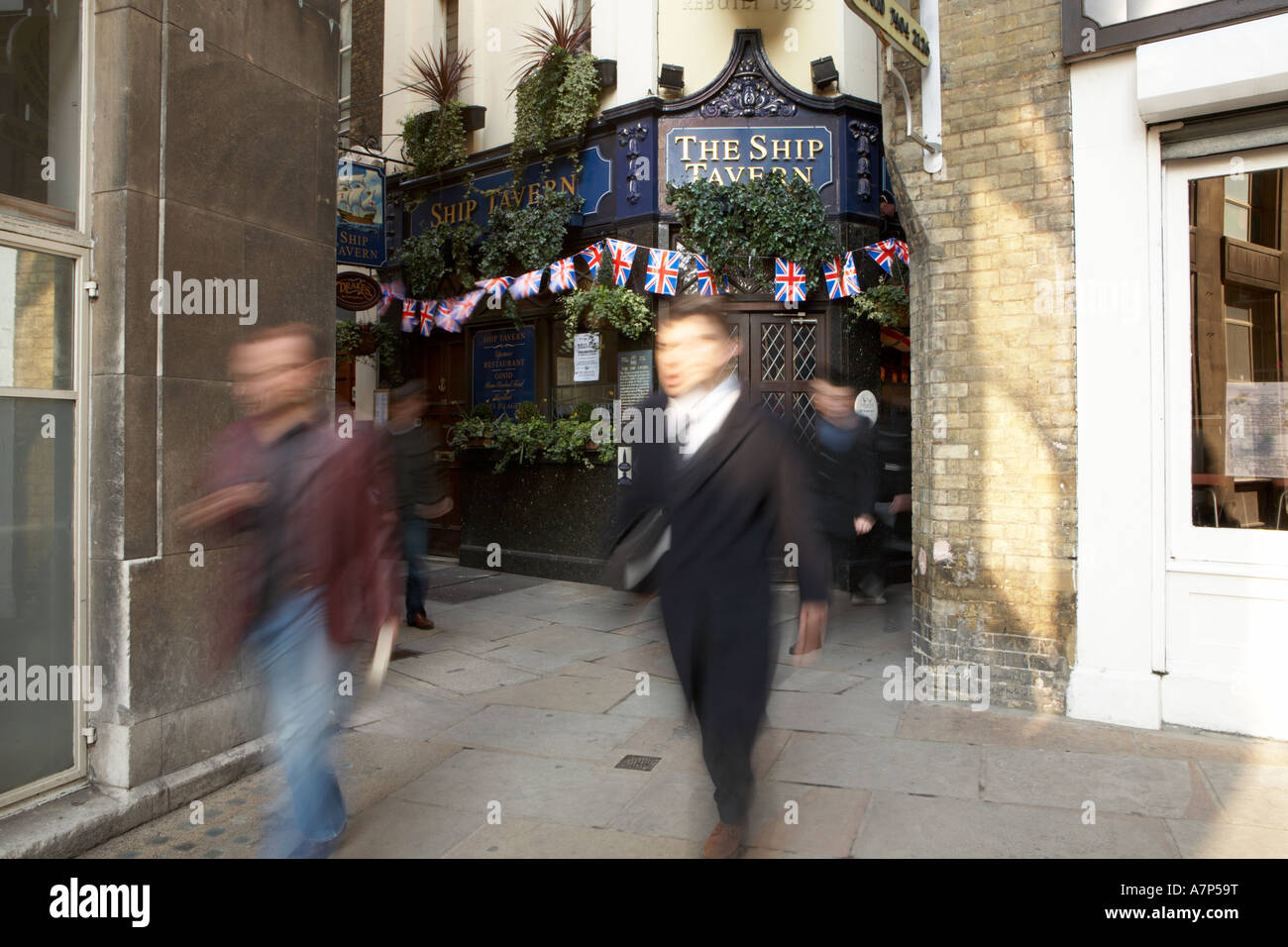 Pedestrians walking past The Ship Tavern pub in London city England UK 15 03 2007 Stock Photo