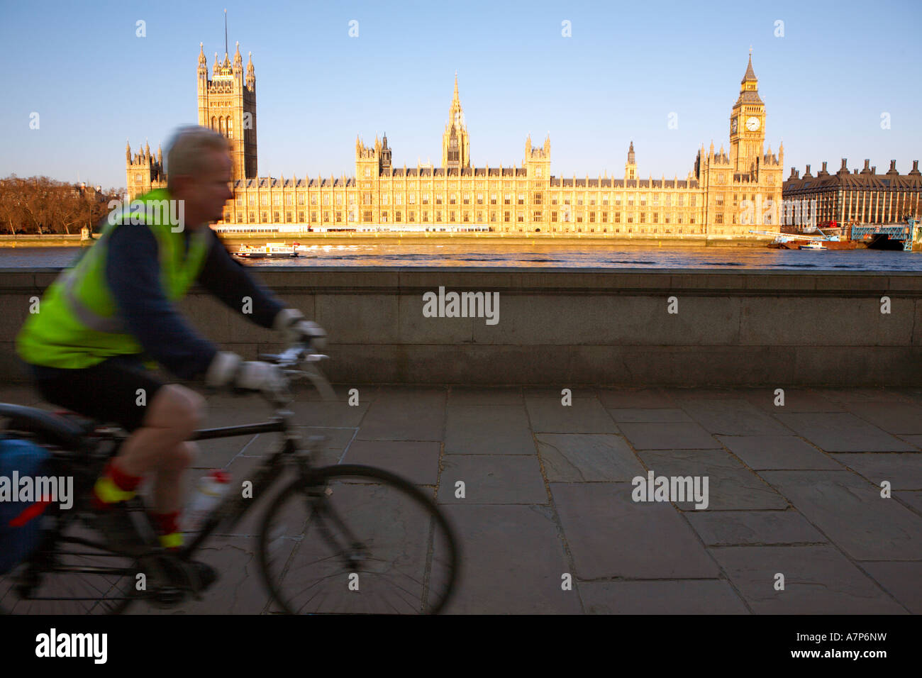 Cycling along the Albert Embankment opposite the Houses of Parliament in London city England UK 15 03 2007 Stock Photo