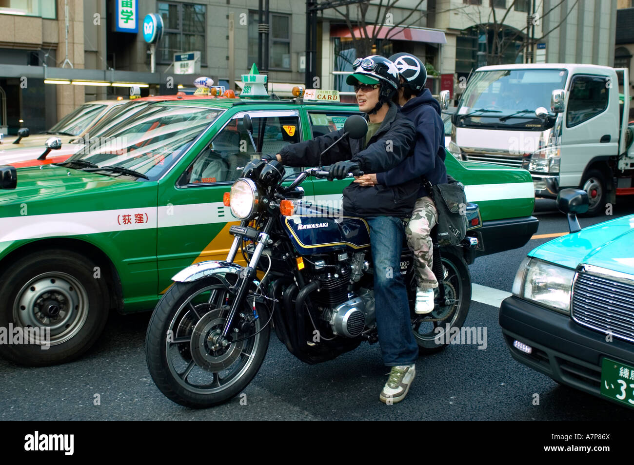 Ginza Tokyo s smartest shopping area taxi cab motorcycle bike motorbicycle motorbike traffic Stock Photo