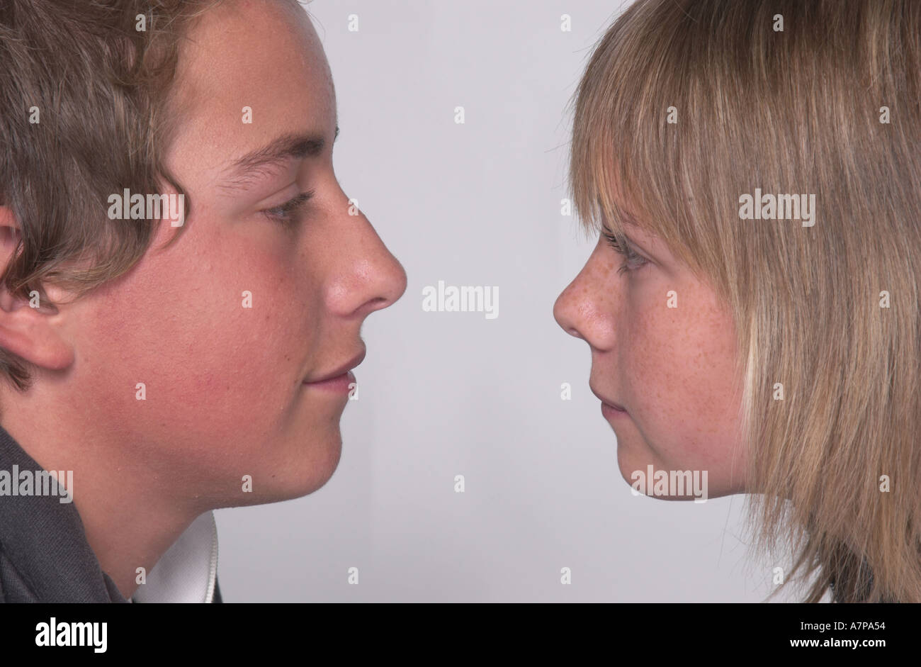 teen boy and girl looking at each other Stock Photo - Alamy