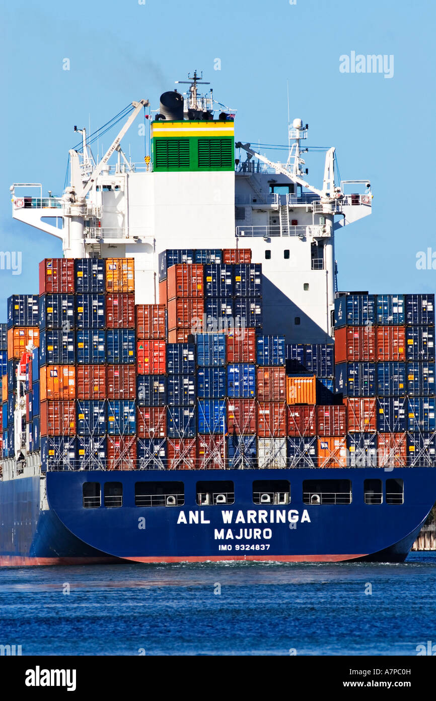 Shipping Industry / A container ship stacked with containers sails