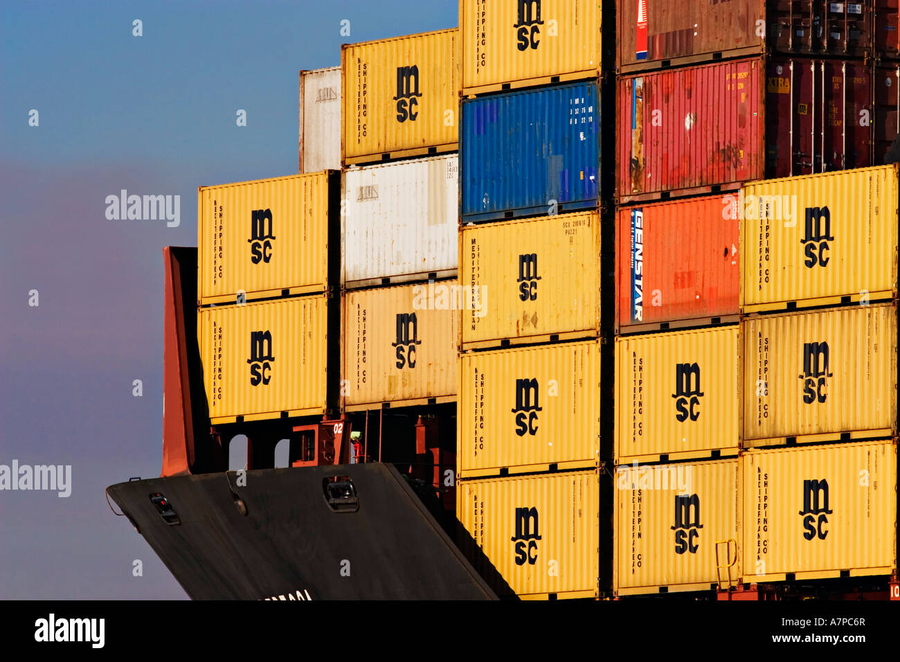 Shipping Industry / Shipping Containers stacked high on the forward deck of a Container Ship