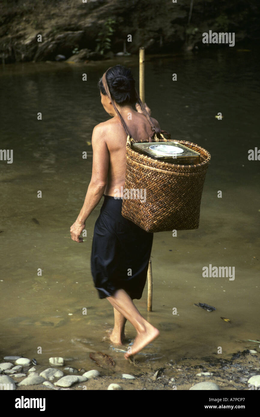 woman is going for water at  the longhouse Kujoh of the Dayak Iban, Malaysia, Sarawak Stock Photo