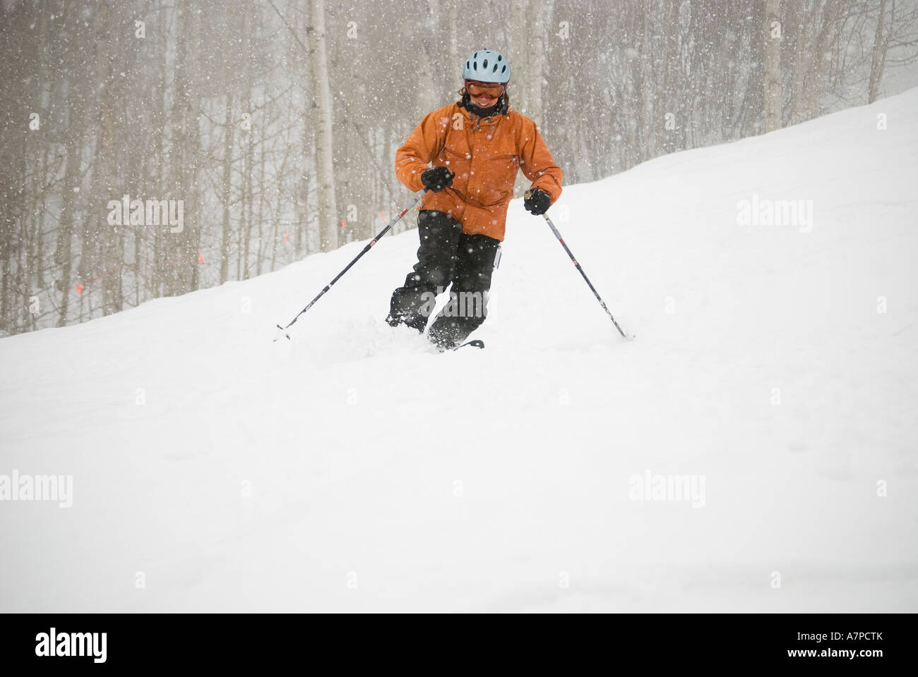 Female telemark skier turning on mogul, Snowmass Mountain, Aspen, Colorado. Stock Photo