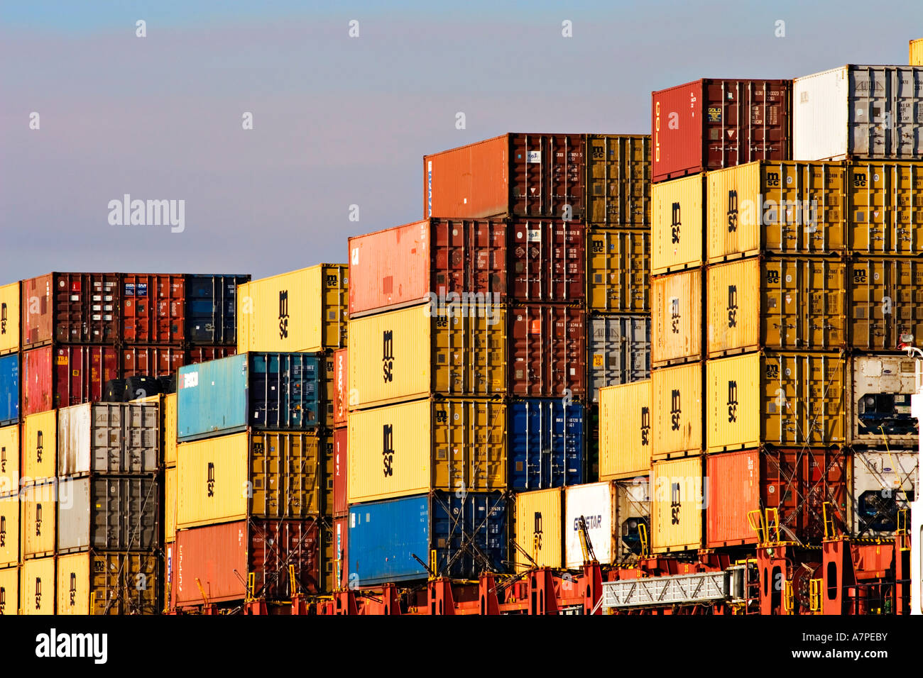 Shipping Industry / Shipping Containers stacked high on the forward deck of a Container Ship