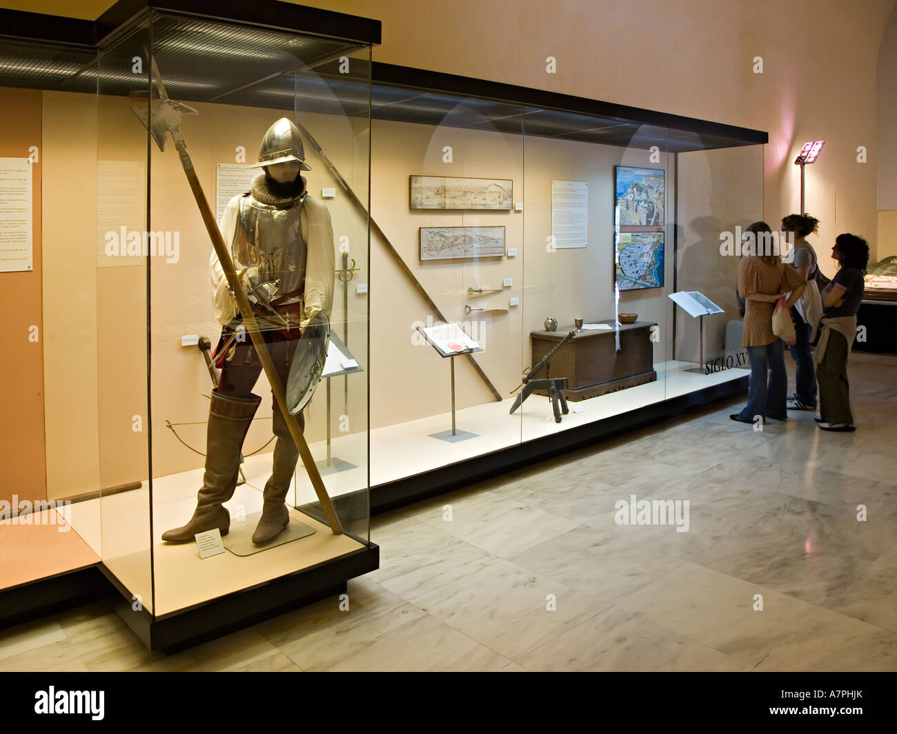 Spanish armour in museum display with visitors viewing cabinets Gibralfaro Malaga Spain Stock Photo