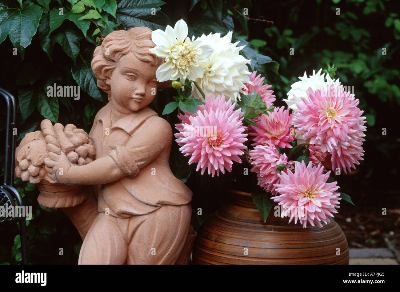 georgina (Dahlia spec.), in vasewith ceramic figure, Germany Stock Photo