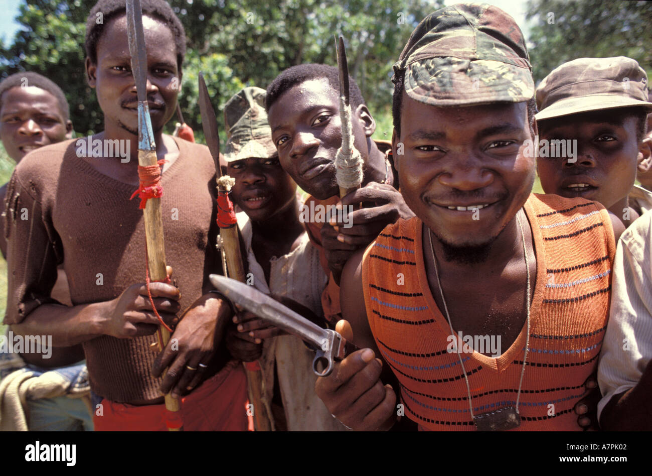 Frightening paramilitary  men with spears and knives call themselves liberators freedom fighters in jungle Mozambique Stock Photo