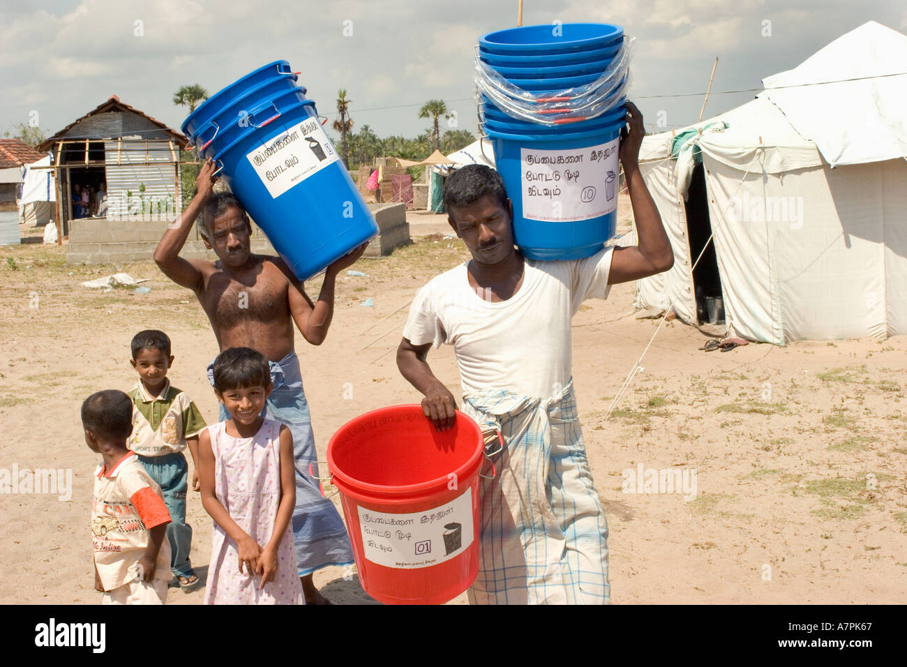 Distributing waste bins at Sigiram IDP displaced peoples camp after the tsunami in Sri Lanka