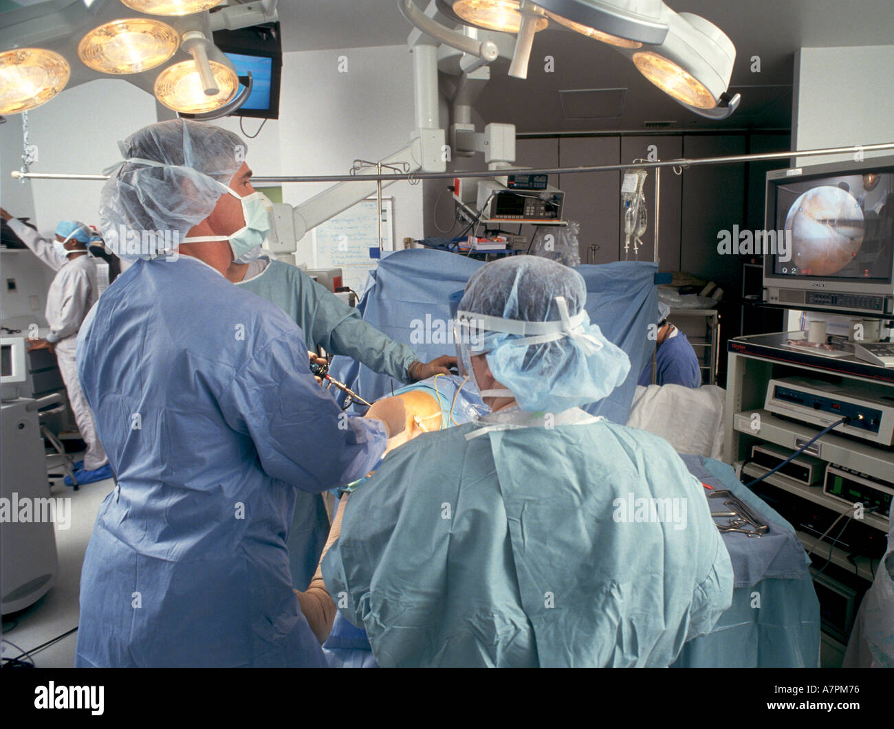 Surgeon uses arthroscope to operate on patient s knee Stock Photo