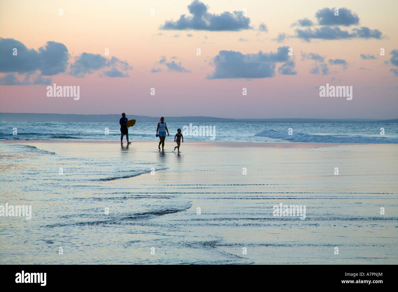A family walking on the beach in Mozambique coast at dusk Barra Mozambique Stock Photo