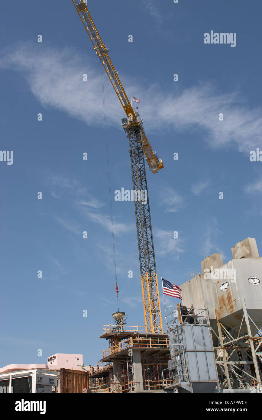 Large crane in operation with American Flag flying Stock Photo