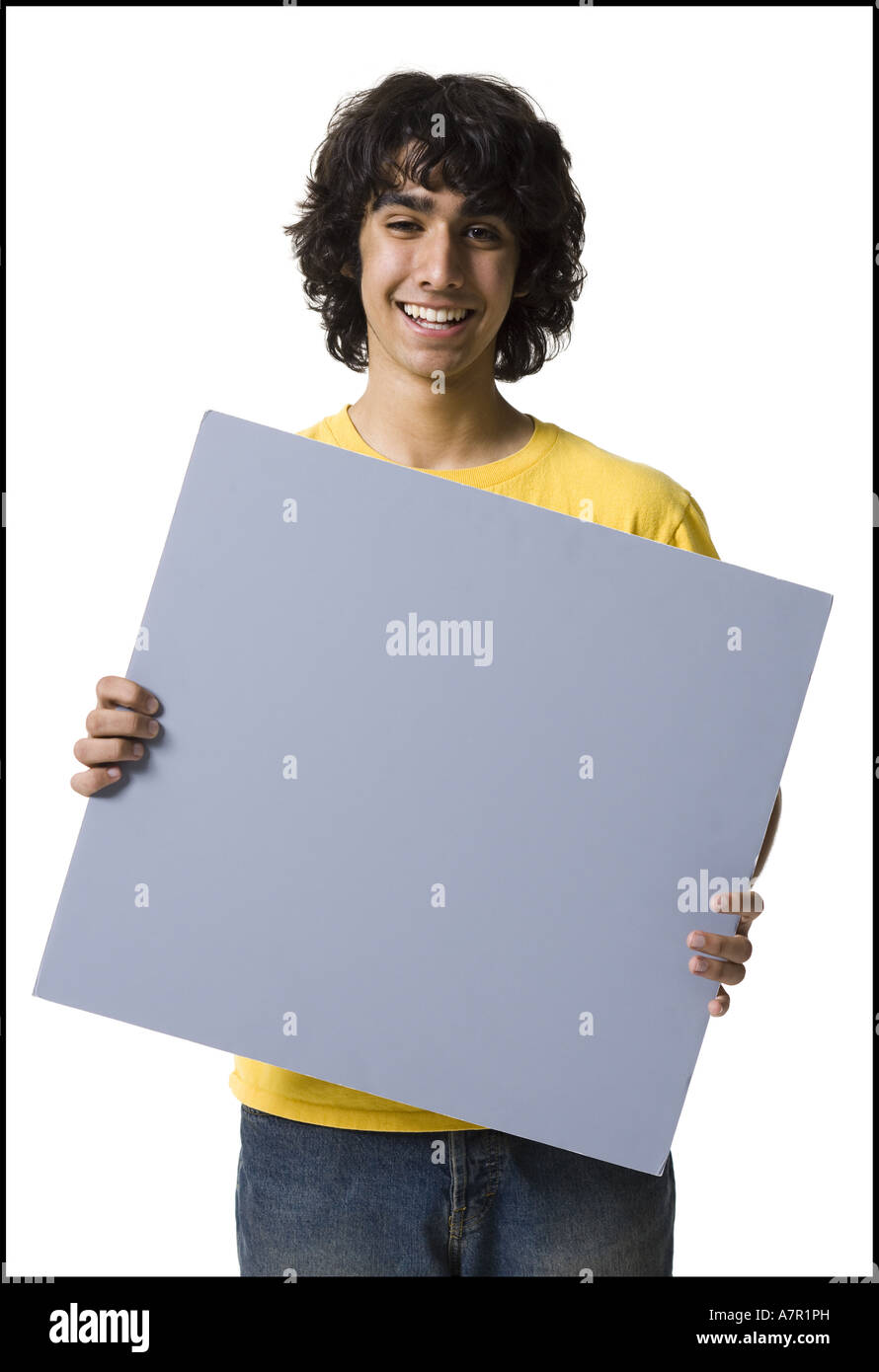 Teenage boy holding blank sign Stock Photo - Alamy