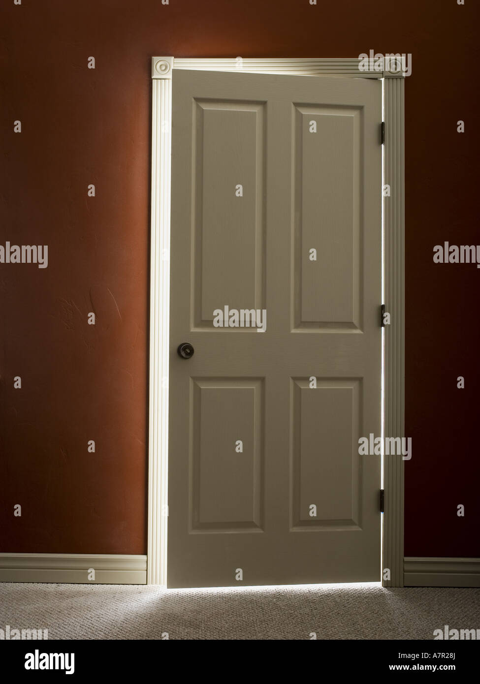 Door slightly ajar with light Stock Photo Alamy