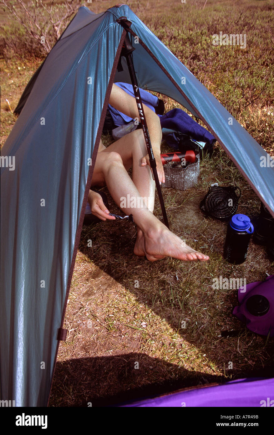 woman shaving her legs at camp in the arctic natiional wildlife refuge alaska Stock Photo