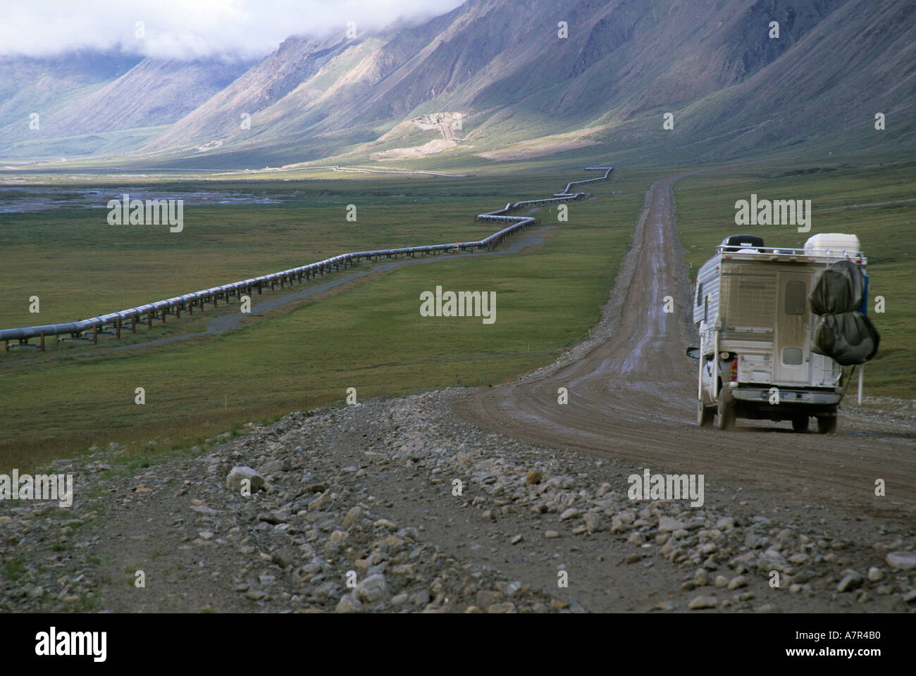 camper heads north on dalton highway pipeline on left Stock Photo