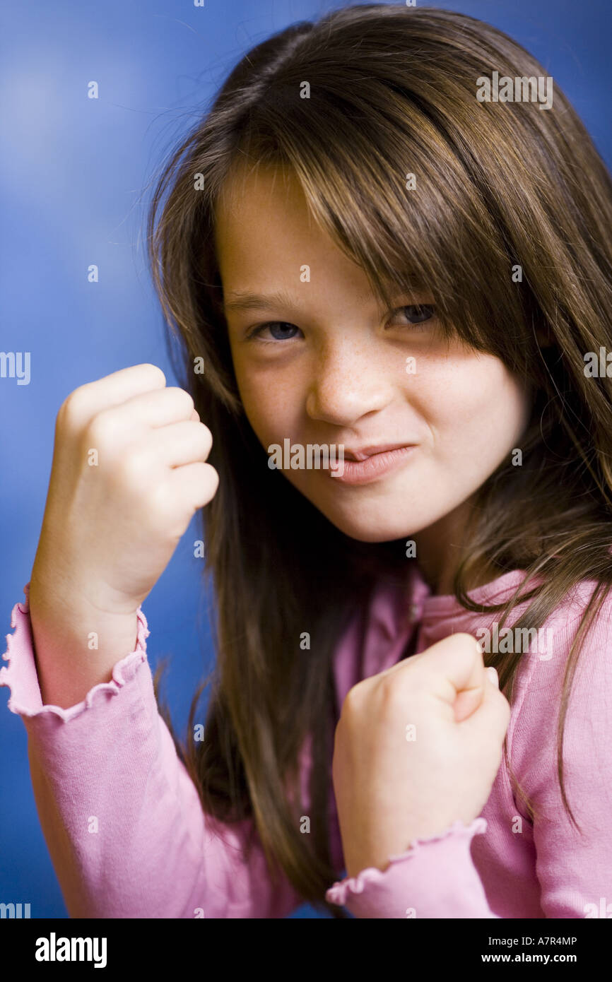 Girl with clenched fists smiling Stock Photo Alamy
