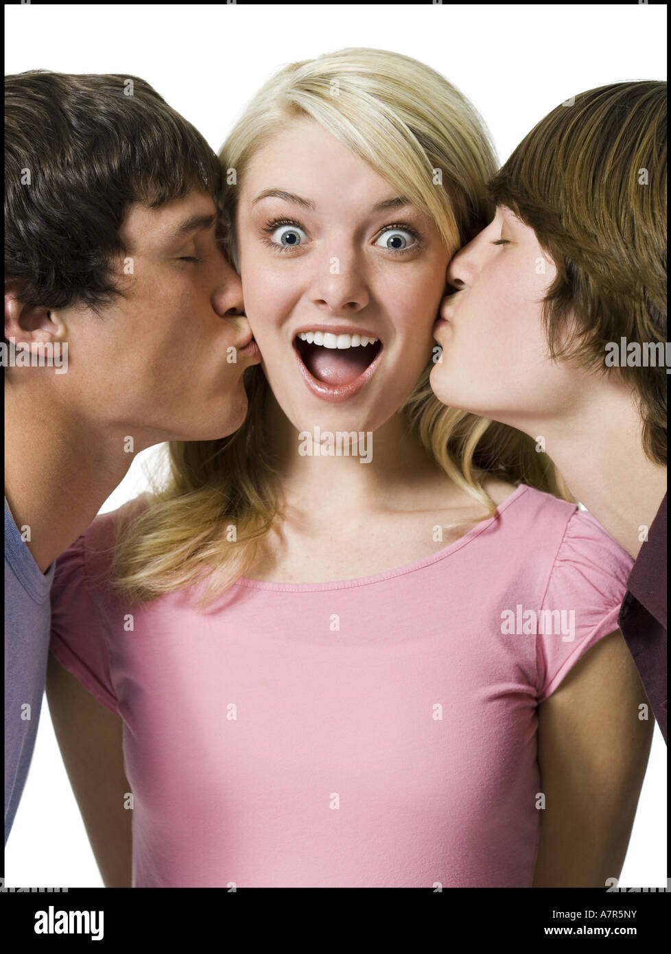 Girl being kissed on both cheeks by two boys Stock Photo Alamy
