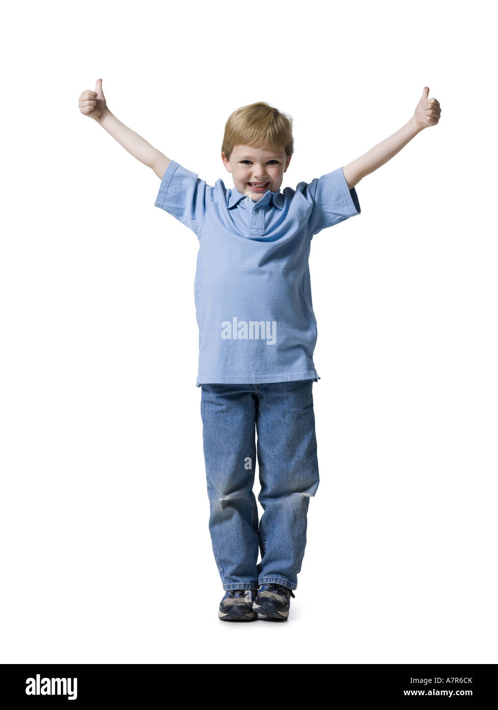 Boy standing with thumbs up smiling Stock Photo - Alamy