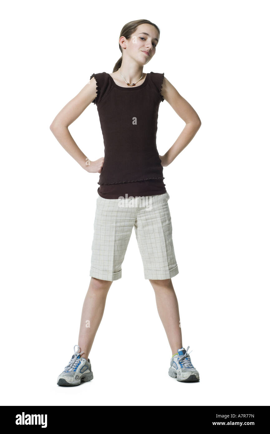 Girl standing with hands on hips Stock Photo - Alamy
