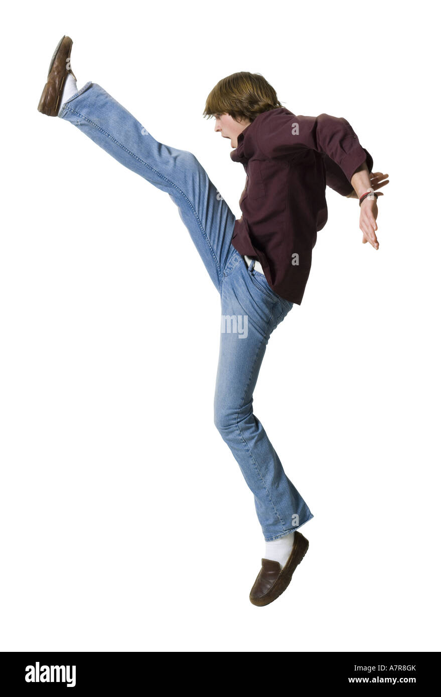 Boy kicking leg up Stock Photo Alamy