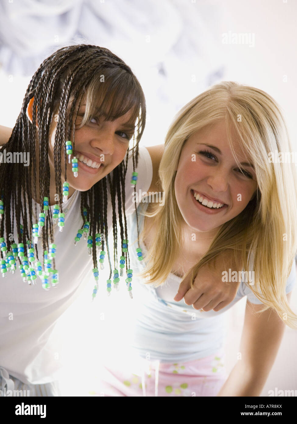 Two girls smiling and hugging Stock Photo - Alamy