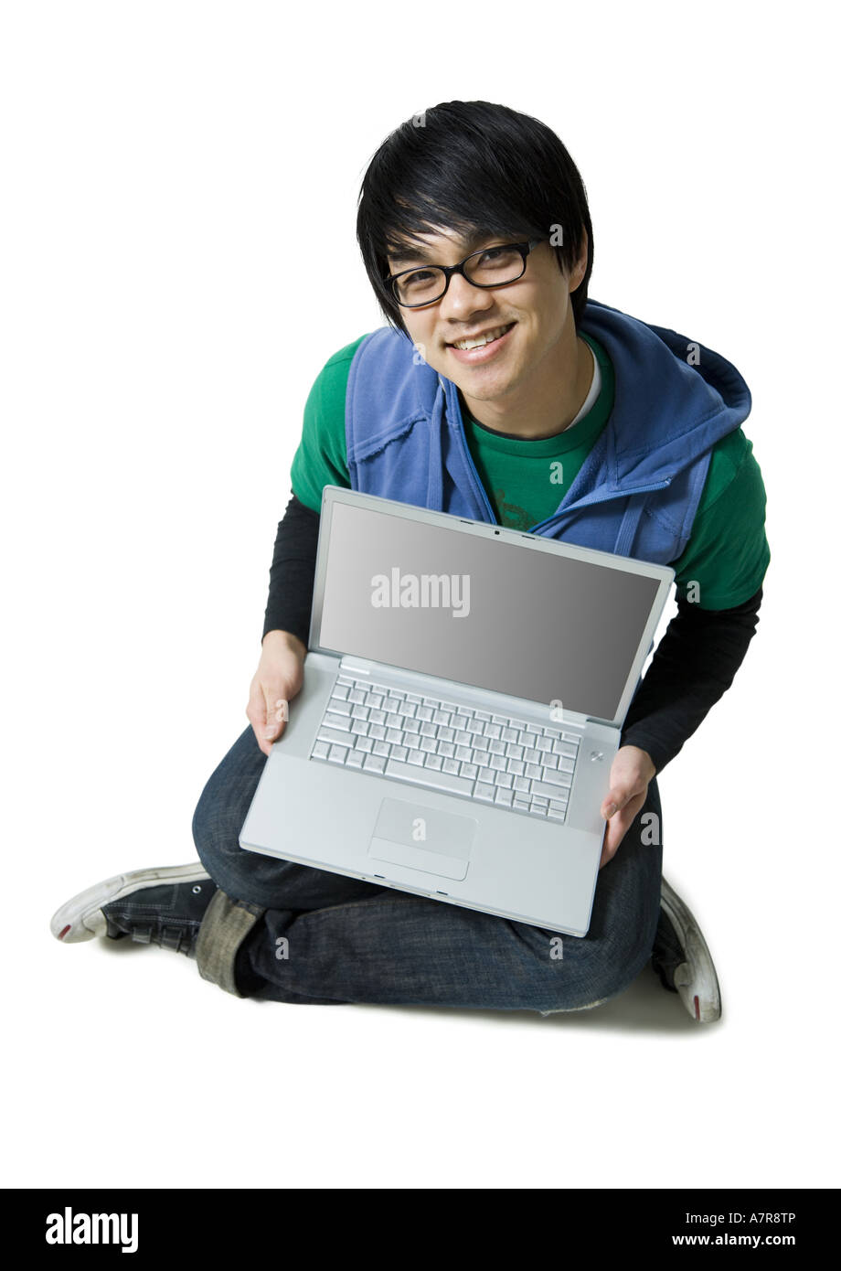 Man with laptop sitting cross legged smiling Stock Photo - Alamy