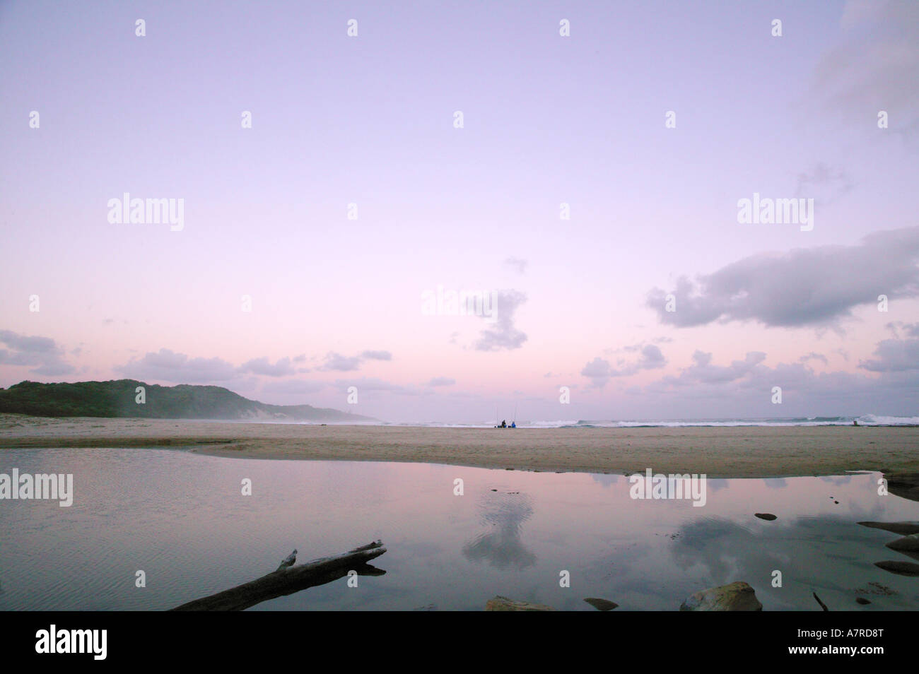 Tranquil seaside scene with two distant fishermen on a beach Haga Haga Eastern Cape South Africa Stock Photo
