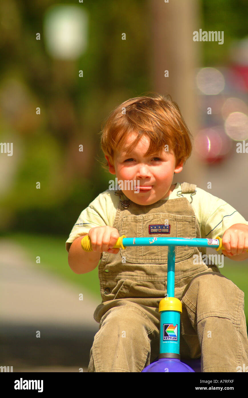Boy on tricycle Stock Photo Alamy