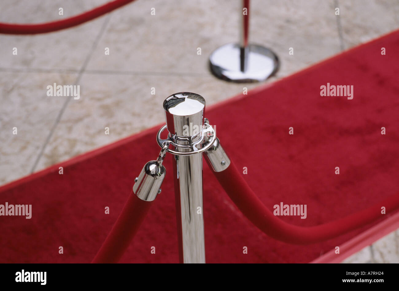 Velvet ropes and red carpet on sidewalk for awards ceremony. 'Red Carpet' treatment. Stock Photo