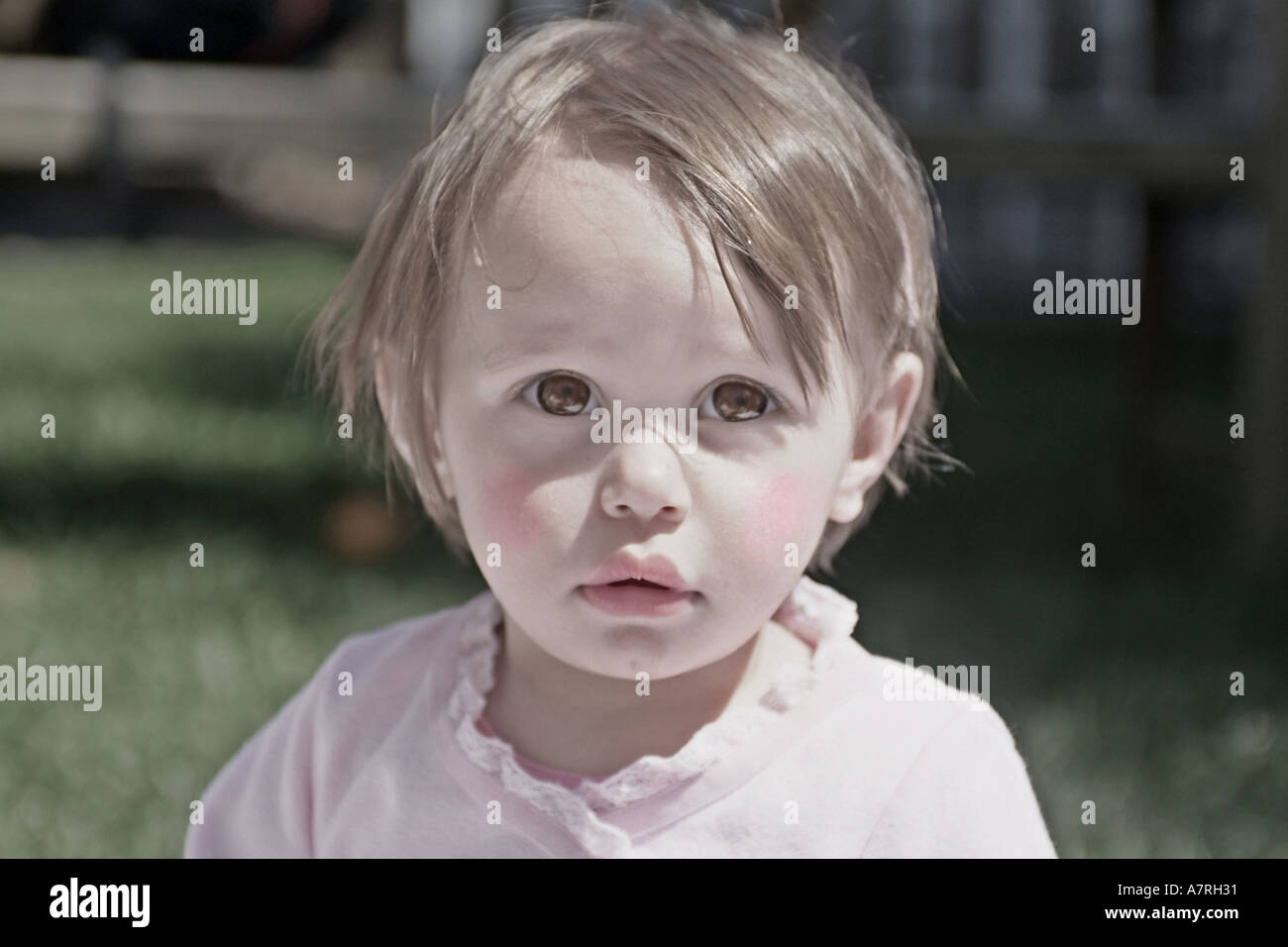 Little baby girl that looks like doll colorized image. Stock Photo