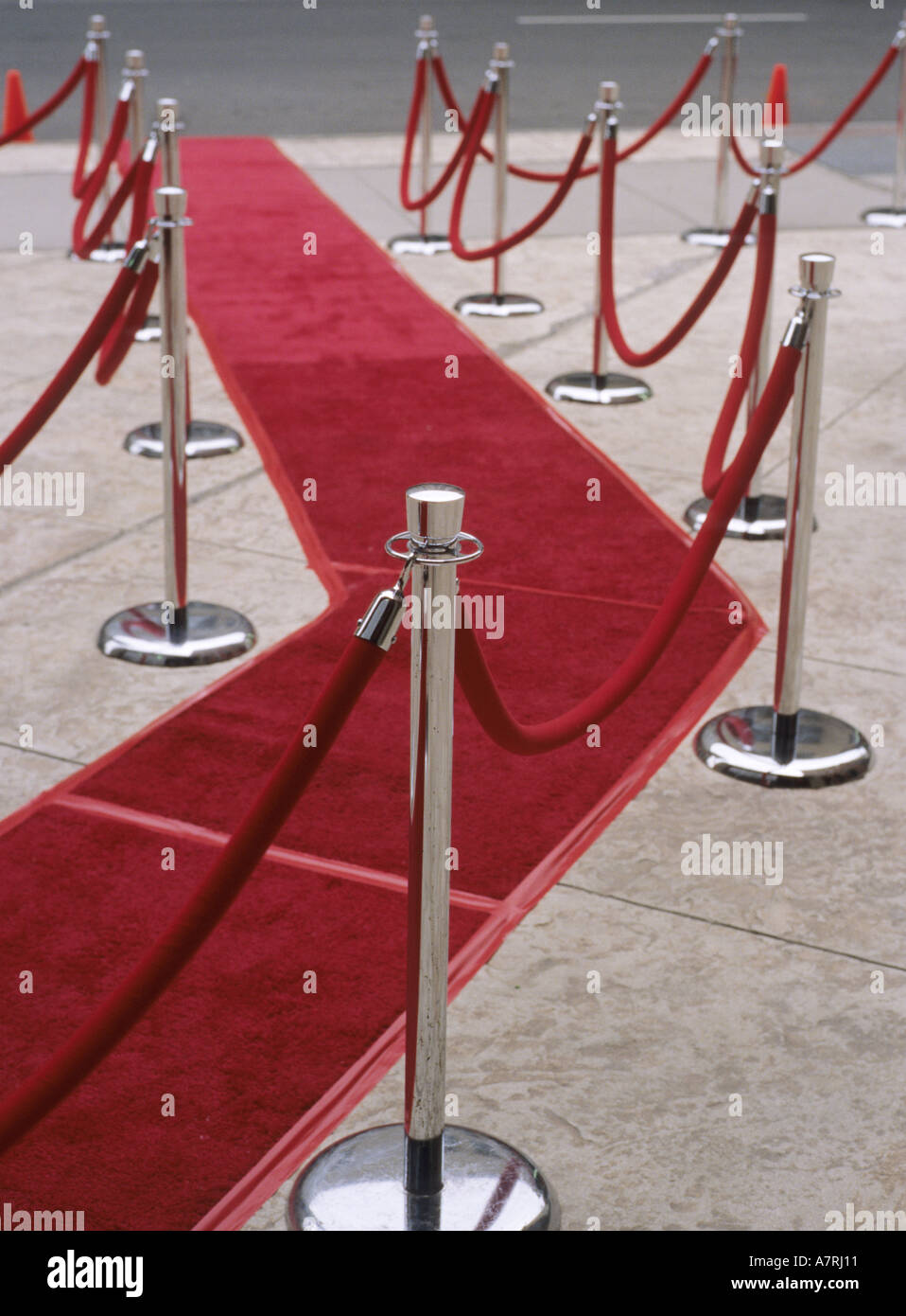 Velvet ropes and red carpet on sidewalk for awards ceremony Stock Photo