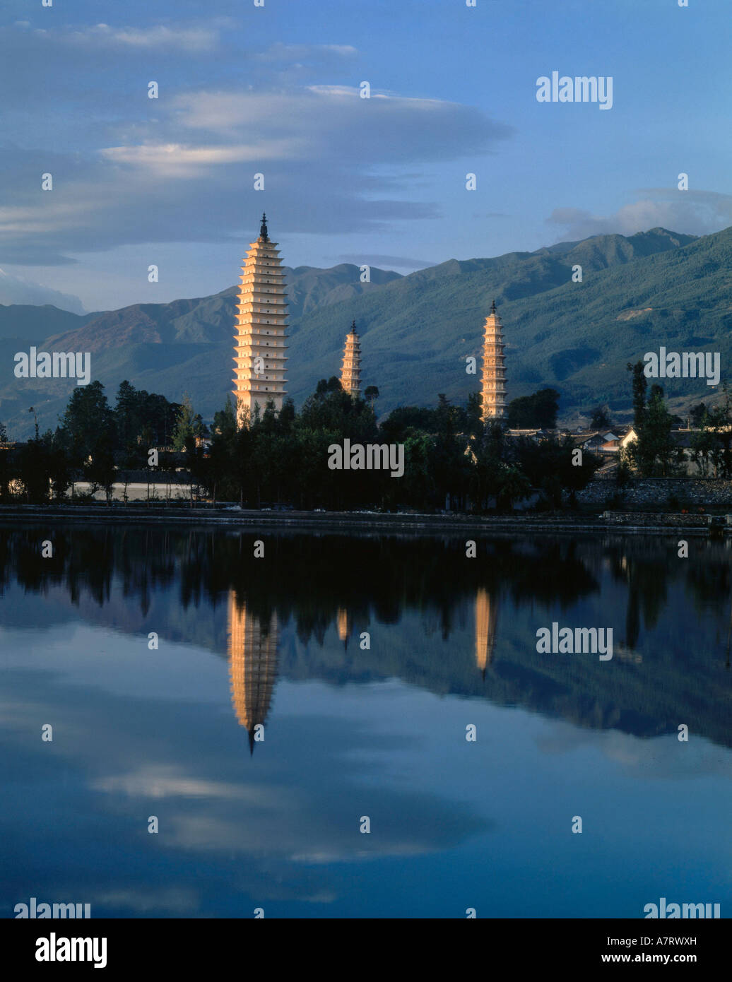 Pagodas reflected in river at dusk, China Stock Photo
