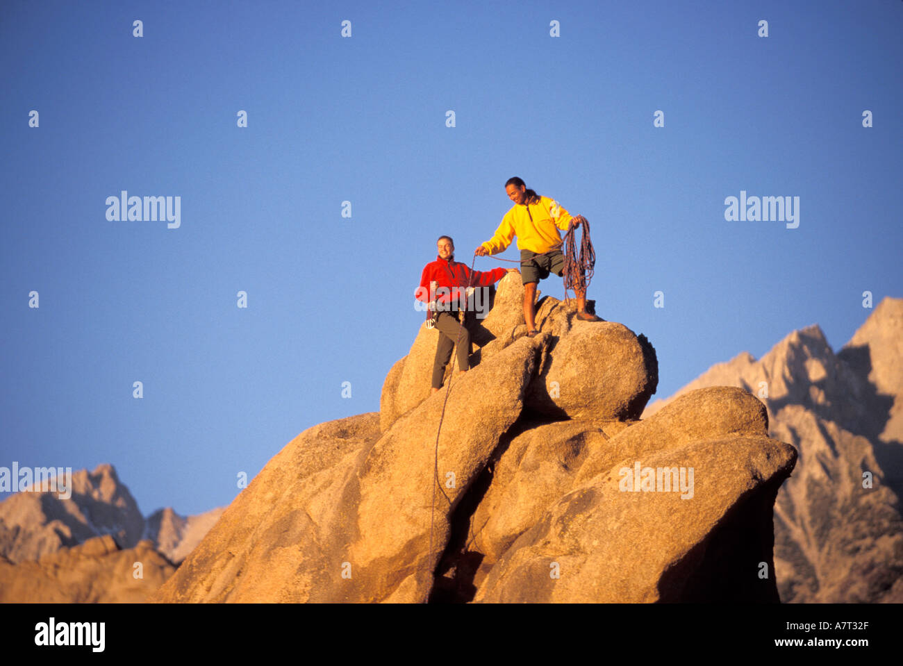 Man and woman climbing on rocks hi-res stock photography and images - Alamy