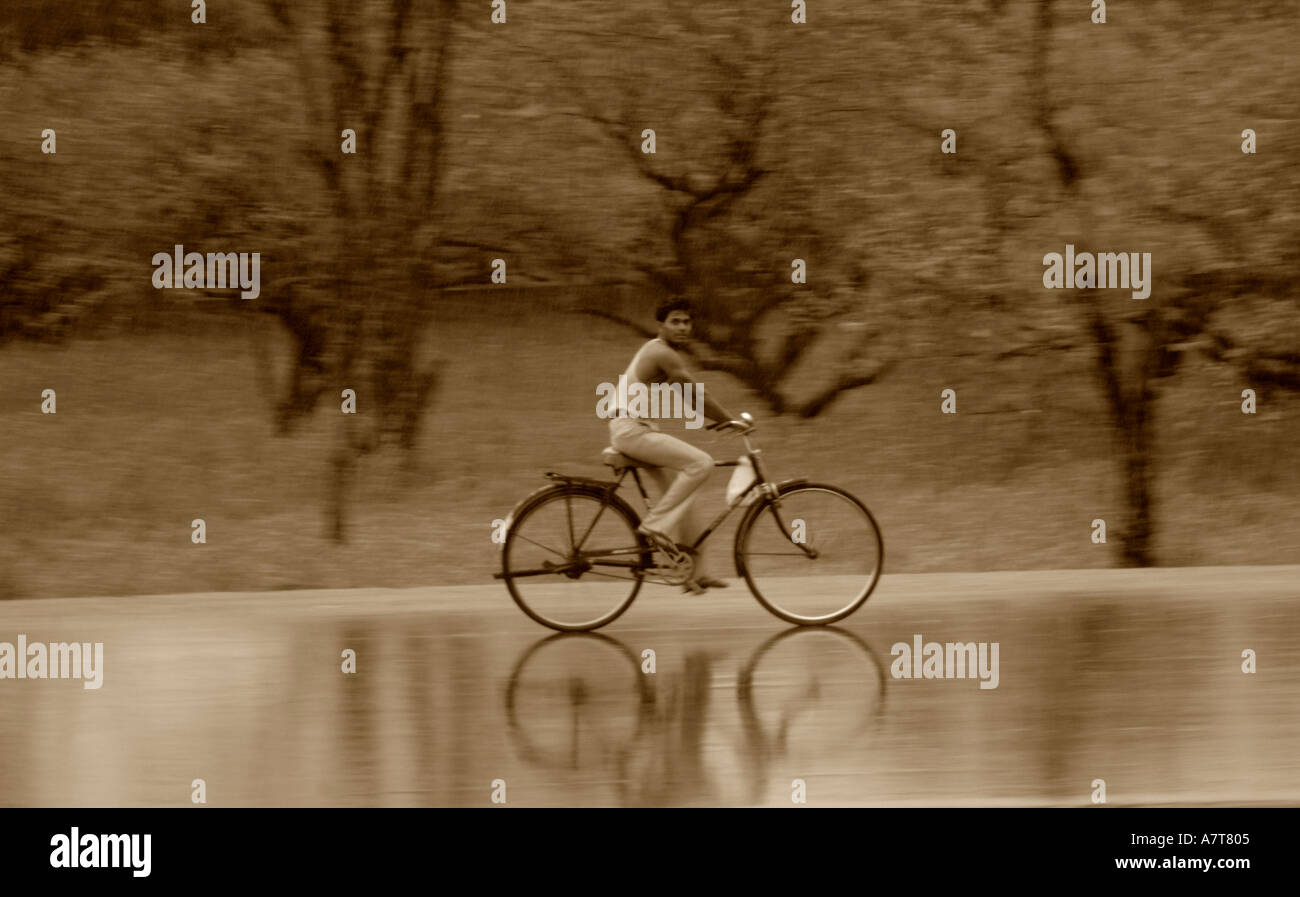 CYCLING IN INDIA DURING MONSOON Stock Photo